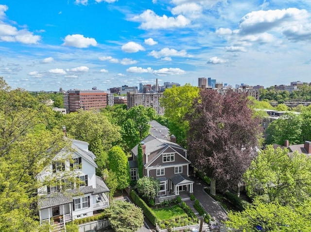 view of urban area featuring a tree filled landscape