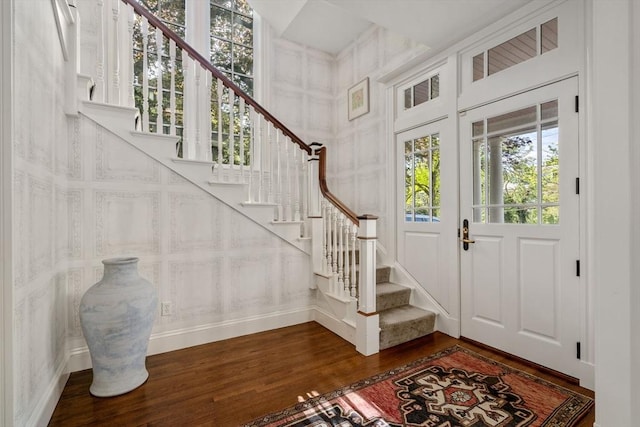 entrance foyer featuring dark wood-type flooring and stairway
