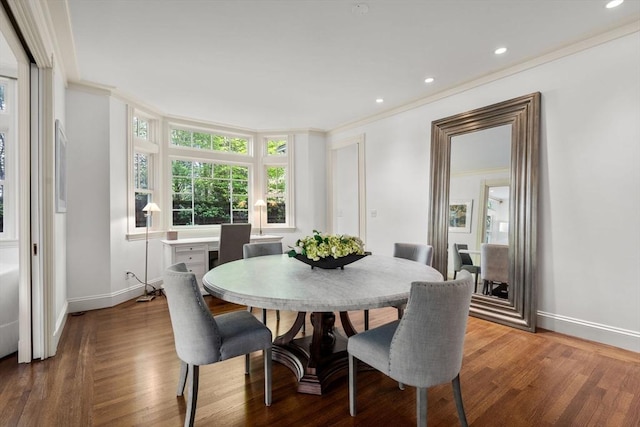 dining space featuring ornamental molding, baseboards, wood finished floors, and recessed lighting