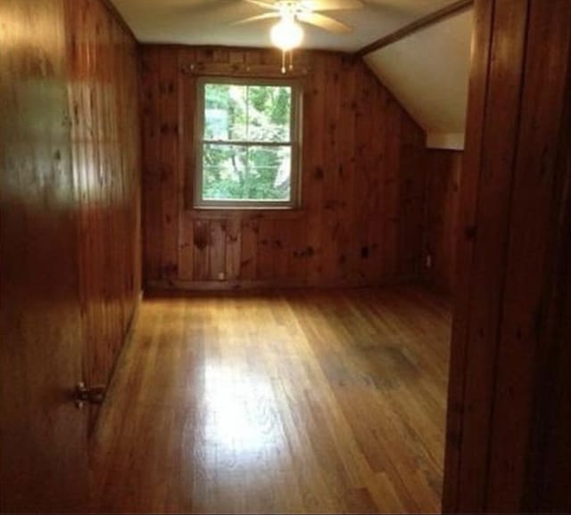 83 Brigham St, Hudson, MA 01749 - additional living space featuring ceiling fan, light wood finished floors, wood walls, and vaulted ceiling