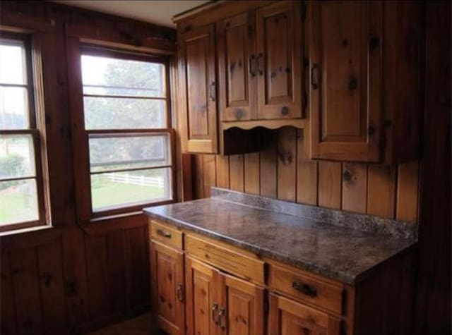 83 Brigham St, Hudson, MA 01749 - kitchen featuring dark countertops and brown cabinetry