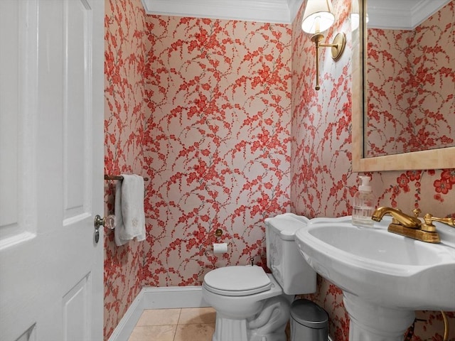 half bathroom with wallpapered walls, baseboards, crown molding, toilet, and tile patterned flooring