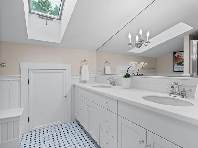 bathroom featuring a skylight and double vanity