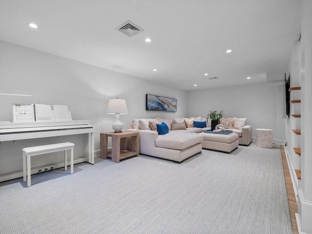 living area with recessed lighting, stairs, and baseboards