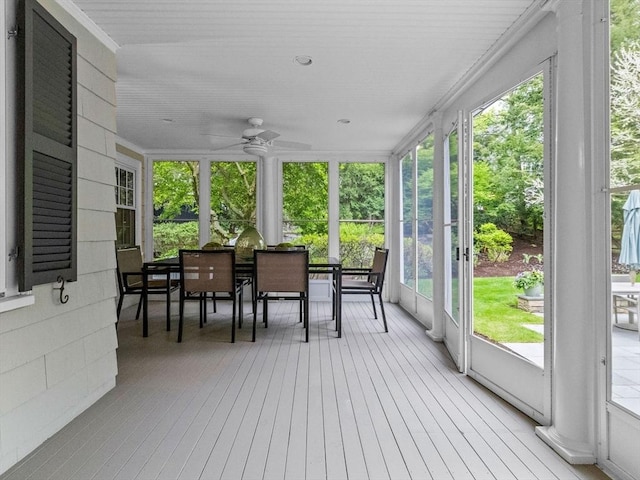 sunroom / solarium with a ceiling fan and plenty of natural light