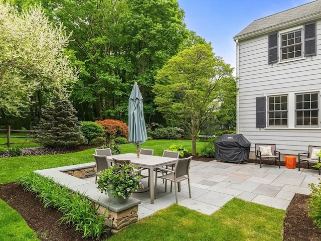 view of patio with a grill and outdoor dining area