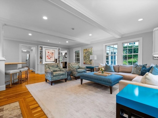 living room featuring ornamental molding, beamed ceiling, recessed lighting, and baseboards