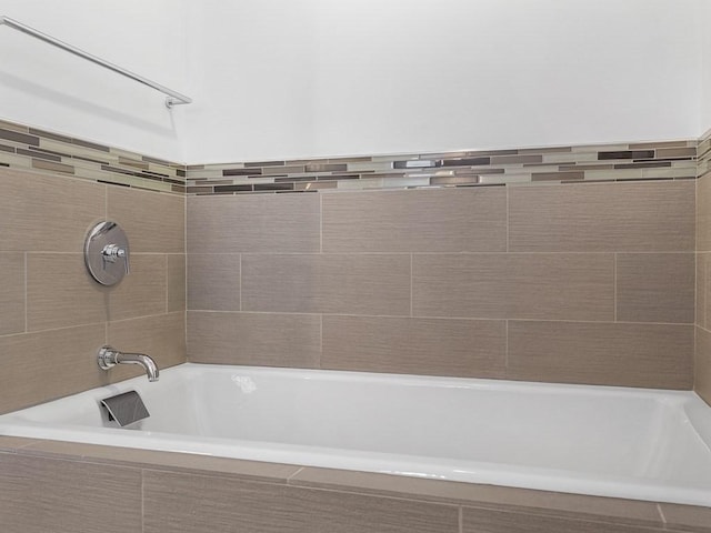 bathroom with tiled tub