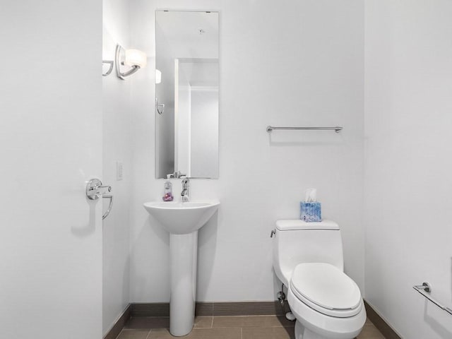 bathroom with sink, tile patterned floors, and toilet