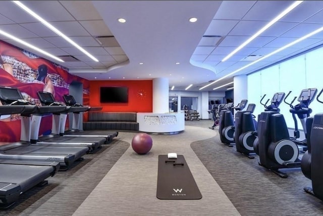 exercise room featuring carpet and a paneled ceiling