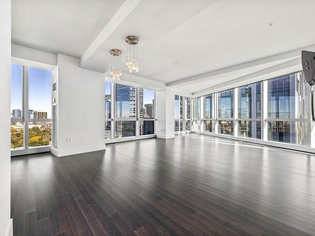 unfurnished living room with expansive windows, hardwood / wood-style floors, and a notable chandelier