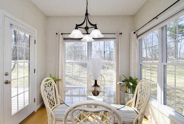 dining room with light wood-type flooring and baseboards