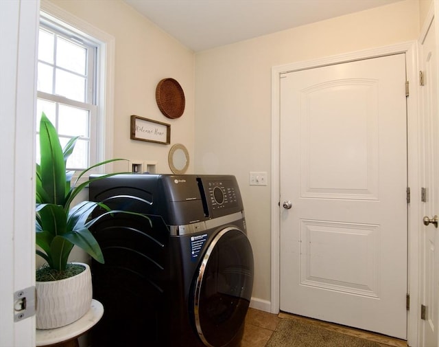 laundry room featuring tile patterned floors, laundry area, and washer / dryer