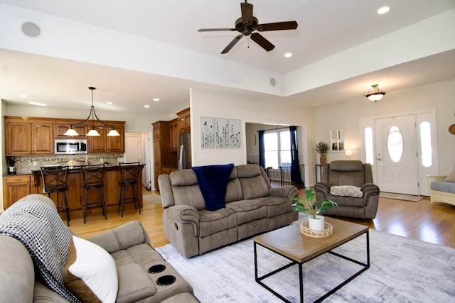 living room with a wealth of natural light, recessed lighting, and light wood finished floors