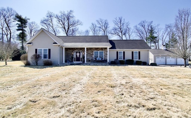 single story home with a porch, a garage, and stone siding