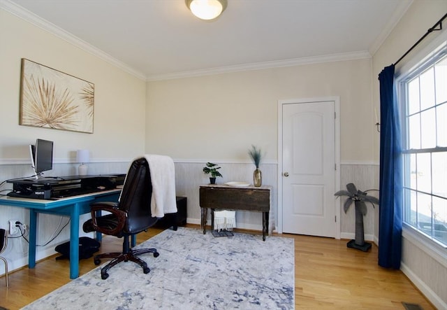 office space with a wainscoted wall, a healthy amount of sunlight, and wood finished floors