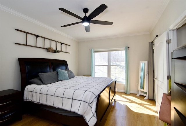 bedroom featuring crown molding, wood finished floors, baseboards, and ceiling fan