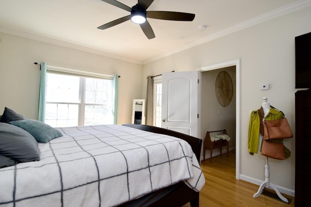 bedroom featuring a ceiling fan, baseboards, light wood-type flooring, and ornamental molding