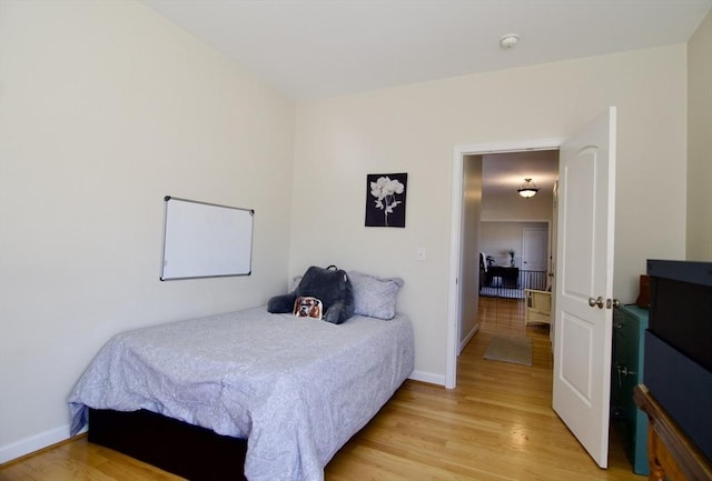 bedroom featuring light wood-style flooring and baseboards