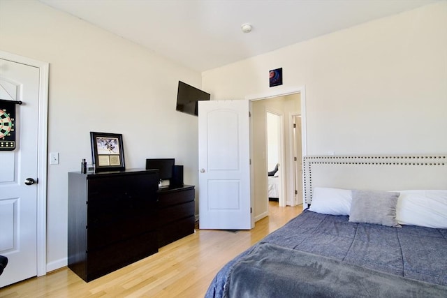 bedroom featuring baseboards and wood finished floors