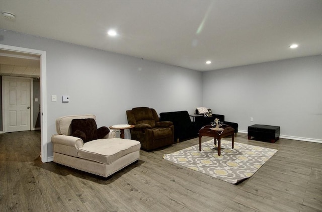 living room with recessed lighting, baseboards, and wood finished floors