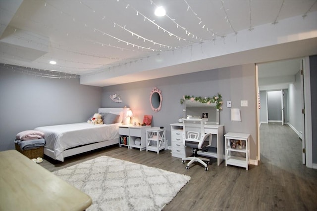 bedroom featuring baseboards and wood finished floors