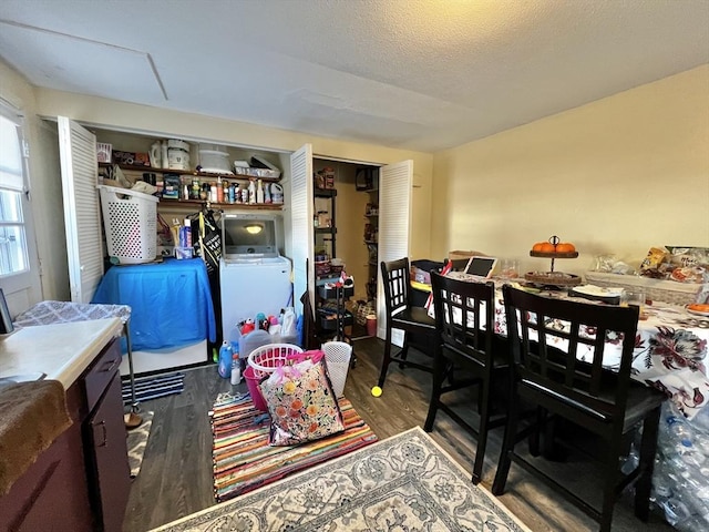 dining room featuring hardwood / wood-style flooring, a textured ceiling, and washer / clothes dryer