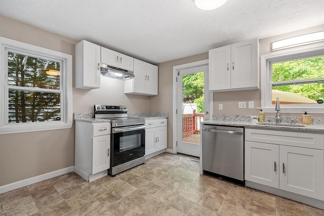 12 Allen Ct Unit 12, Northborough, MA 01532 - kitchen featuring appliances with stainless steel finishes, under cabinet range hood, a sink, baseboards, and white cabinetry