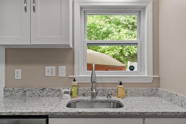 12 Allen Ct Unit 12, Northborough, MA 01532 - kitchen view of a sink, white cabinets, dishwasher, and light stone counters