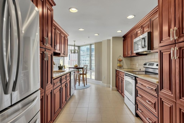 75-83 Cambridge Pkwy Unit W403, Cambridge, MA 02142 - kitchen featuring stainless steel appliances, recessed lighting, baseboards, decorative backsplash, and pendant lighting