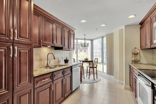 75-83 Cambridge Pkwy Unit W403, Cambridge, MA 02142 - kitchen featuring stainless steel appliances, a sink, baseboards, light stone countertops, and recessed lighting