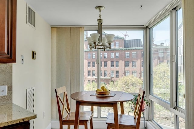75-83 Cambridge Pkwy Unit W403, Cambridge, MA 02142 - dining space featuring a chandelier, healthy amount of natural light, and baseboards