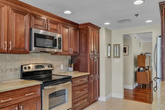 75-83 Cambridge Pkwy Unit W403, Cambridge, MA 02142 - kitchen with appliances with stainless steel finishes, light tile patterned floors, baseboards, decorative backsplash, and ornamental molding
