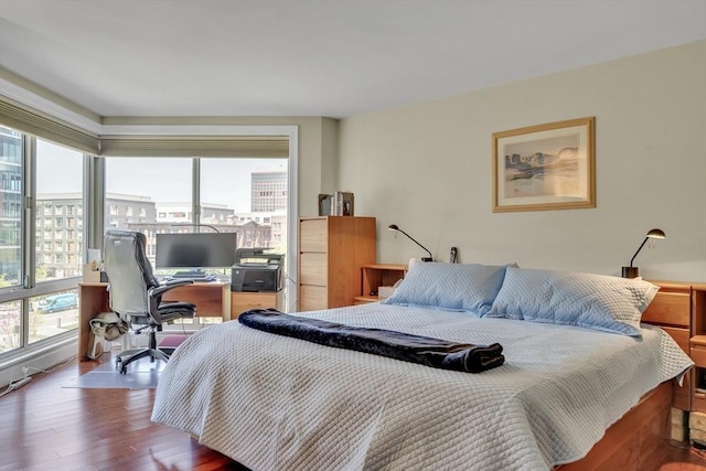 75-83 Cambridge Pkwy Unit W403, Cambridge, MA 02142 - bedroom with multiple windows, an office area, and wood finished floors