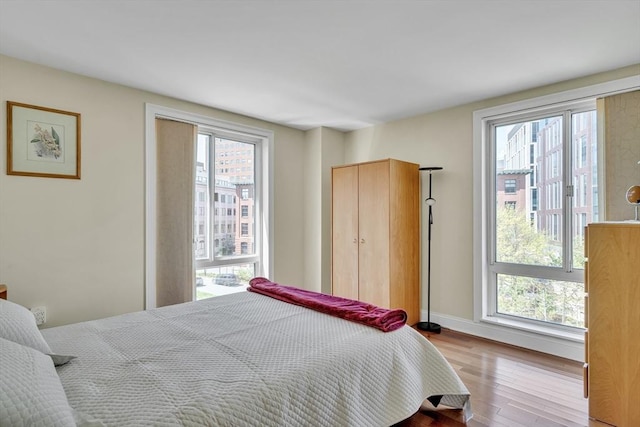 75-83 Cambridge Pkwy Unit W403, Cambridge, MA 02142 - bedroom with wood finished floors and baseboards