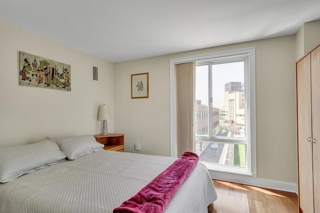 75-83 Cambridge Pkwy Unit W403, Cambridge, MA 02142 - bedroom featuring wood finished floors and baseboards
