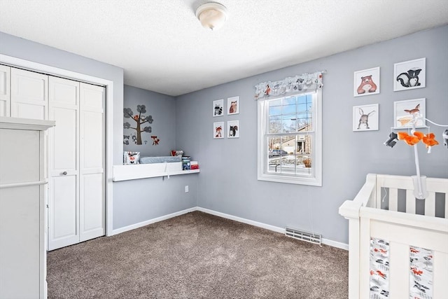 bedroom featuring a closet, carpet floors, and a textured ceiling