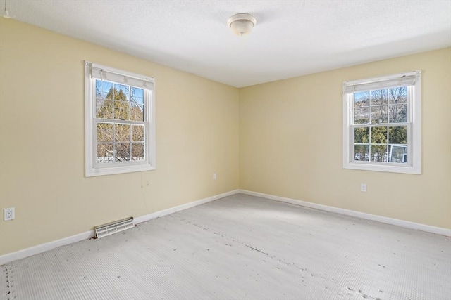 spare room featuring plenty of natural light