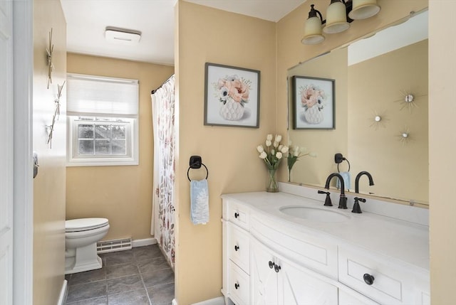 bathroom with tile patterned flooring, vanity, and toilet