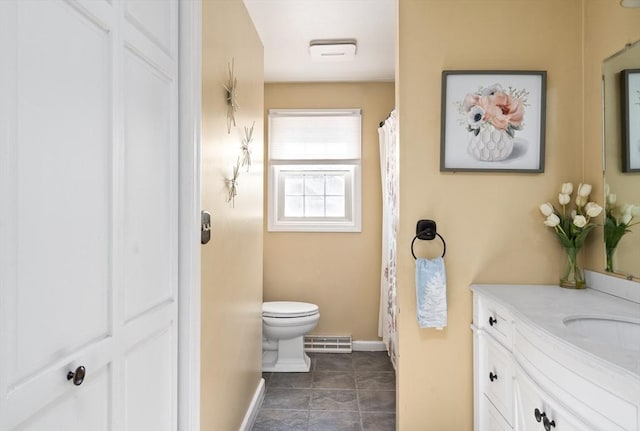 bathroom featuring tile patterned flooring, vanity, and toilet