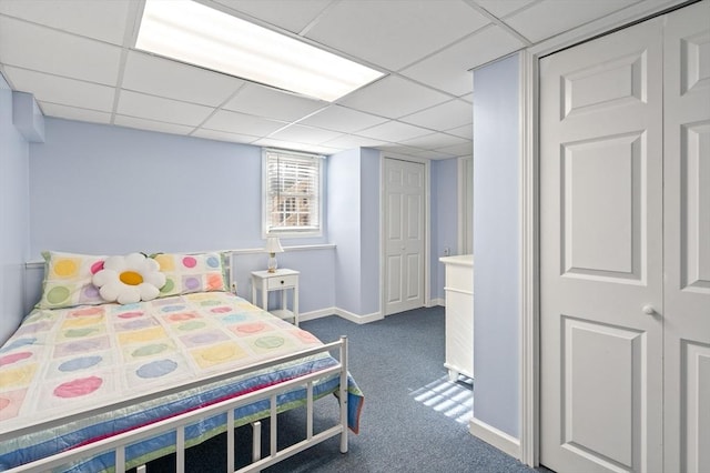 carpeted bedroom featuring a paneled ceiling