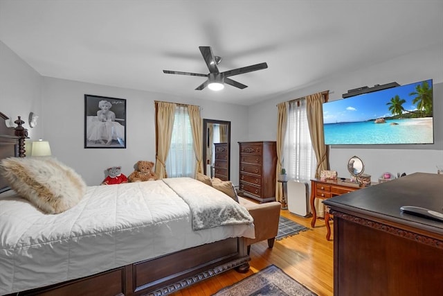 bedroom featuring light wood-style floors and ceiling fan