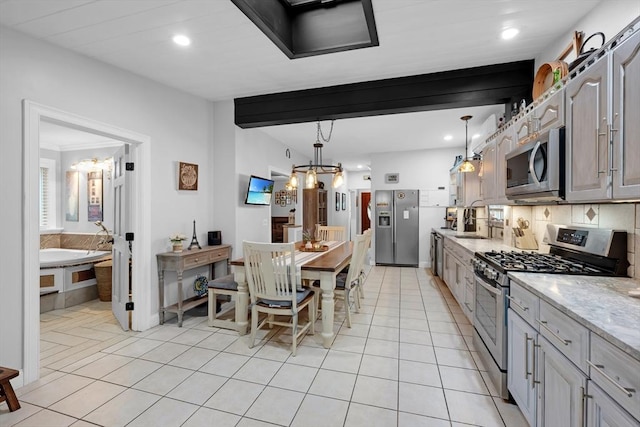 kitchen with stainless steel appliances, recessed lighting, light tile patterned floors, tasteful backsplash, and a chandelier