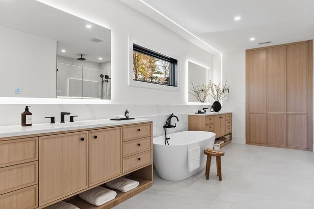 936 Central Ave, Needham, MA 02492 - full bathroom featuring vanity, a shower stall, a soaking tub, and recessed lighting