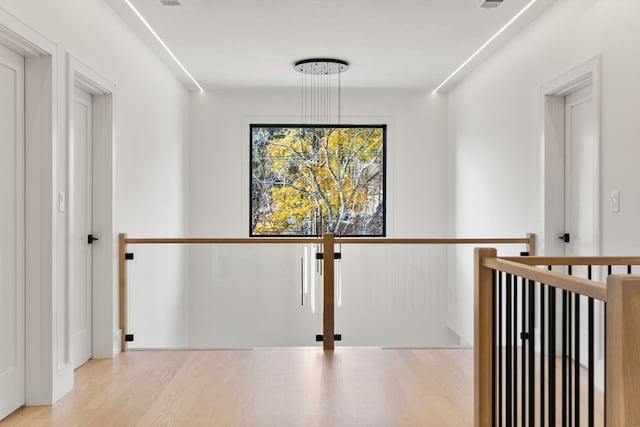 hallway with light hardwood / wood-style floors