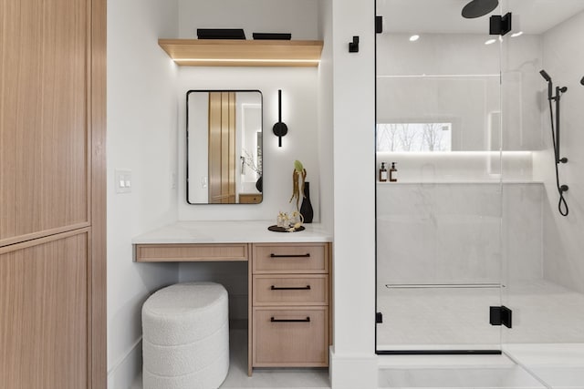 bathroom with walk in shower, vanity, and tile patterned flooring