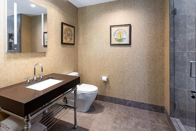 full bathroom with vanity, a shower stall, toilet, and baseboards