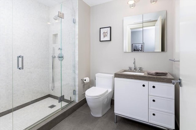 full bathroom featuring tile patterned flooring, toilet, vanity, and a stall shower