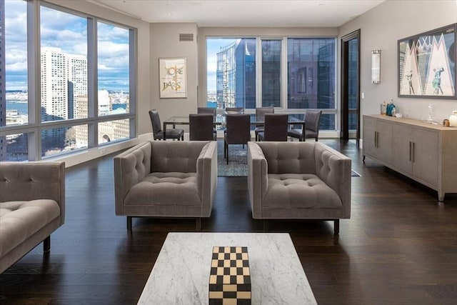 living area featuring visible vents and dark wood-type flooring