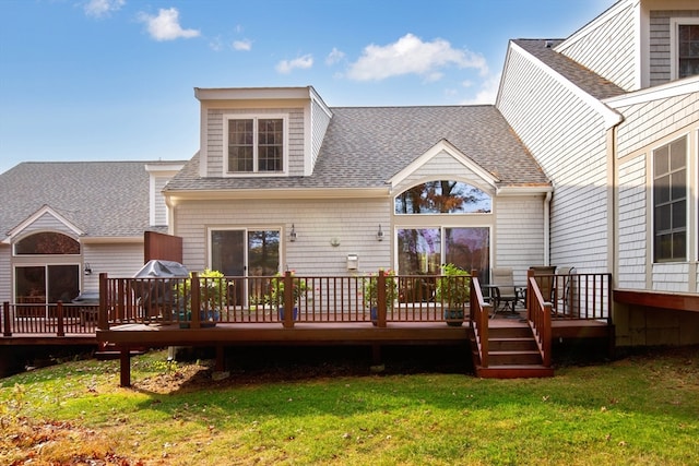 back of house with a deck and a yard